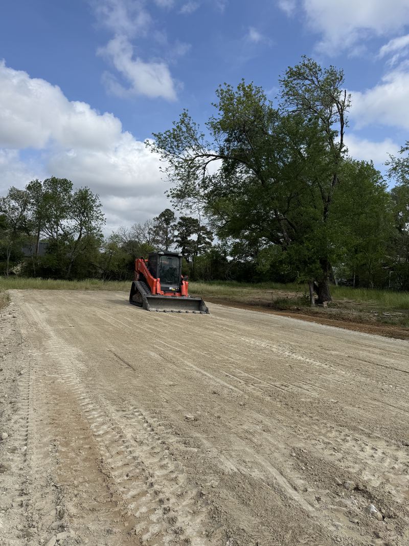 Track loader grading a new driveway
